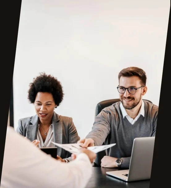 Two executives reviewing candidate documents.